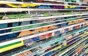 Old faded comic book collection stacked in a pile creates colorful background texture with focus blur effect