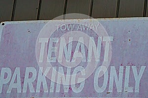 Old faded metal sign rusted with white words tenant parking