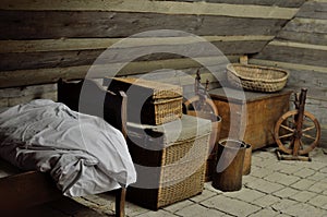 Old fairytale attic with spinning wheels, old bed and chests