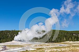 Old Faithful geyser eruption into Yellowstone National Park, USA