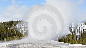 Old faithful in Yellowstone National park footage in the winter with snow