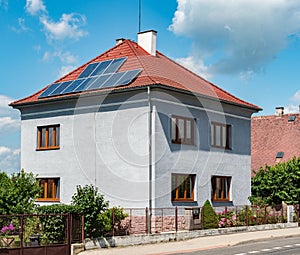 Old family house with modern rooftop with electric solar panels photo