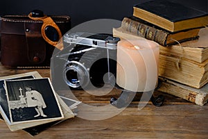 Old family photos 50s, 40s, retro camera, books, glasses for solar eclipse on wooden table, concept of genealogy, memory of