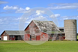 Old farm building stand idle in a deteriorating state