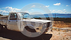 Old farm car on dusty road of Lesvos island