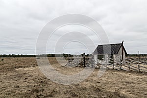 Old farm in the gloomy field