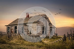 Old farm house in disrepair with a broken fence in the fall