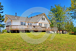 Old farm house with walkout deck. Backyard view photo
