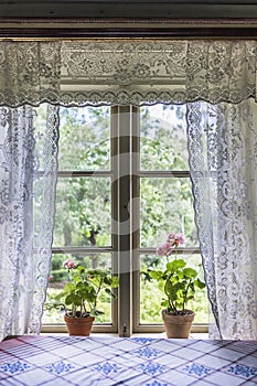 Old farm house window with lace curtains