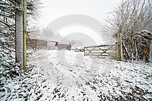 An old farm with a snowy car