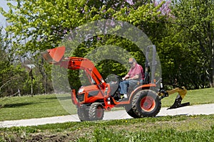 Old Farmer Plowing His Compact Tractor