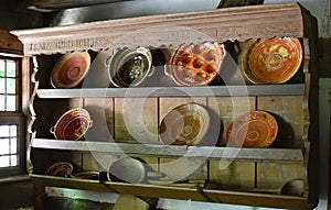 Old farmer village house.Ceramic and metal dishes. Coppers and frying pans for the center.In the wooden cupboard.