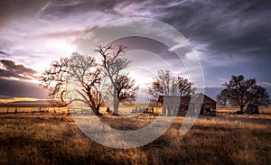 Old Farmhouse at Sunset in a Rural Setting photo