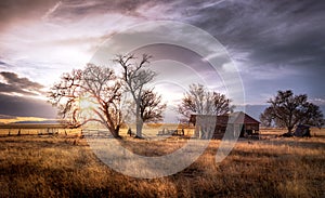 Old Farmhouse at Sunset On a Meadow