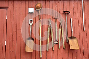 Old farming tools hanging on a barn wall