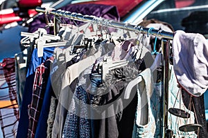 Old fashion clothes on rack for donation,reusing or reselling