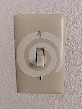 Old fashion light switch on a white wall