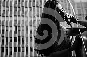 Old fashion town. Vintage concept. Oldstyled city. Woman with payphone. Communication.