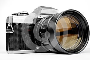 Old-fashion vintage retro camera with big lens isolated on white