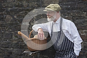 Old fashioned 1940 baker with bread basket