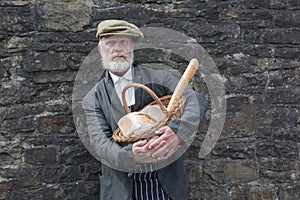 Old fashioned 1940 baker with bread basket