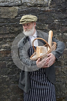 Old fashioned 1940 baker with bread basket