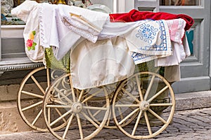Old-fashioned baby carriage with wooden wheels