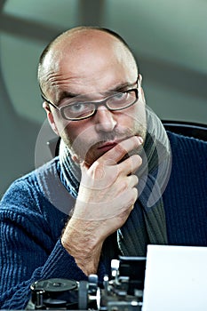 Old fashioned bald writer in glasses