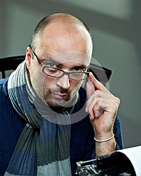 Old fashioned bald writer in glasses