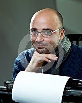 Old fashioned bald writer in glasses