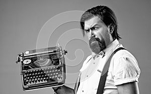old fashioned bearded hipster. trendy man in bow tie use retro typewriter. confident and elegant man holding vintage