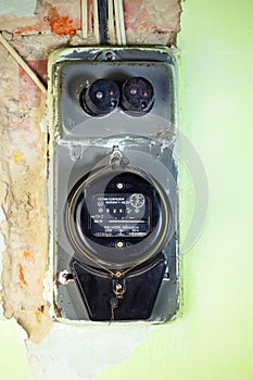 Old-fashioned black meter for measuring consumed electricity digital display for measuring kilowatt hours in old residential