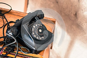 Old fashioned black telephone in retro/vintage style from long gone era