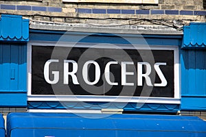 Old Fashioned Grocers Sign above a Shop photo