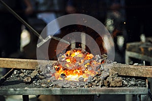 Old fashioned blacksmith furnace with burning coals