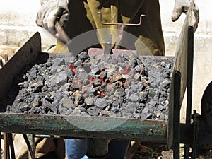 Old-fashioned blacksmith furnace with burning coals for iron work