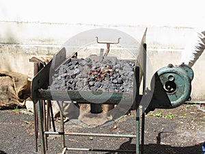 Old-fashioned blacksmith furnace with burning coals for iron work