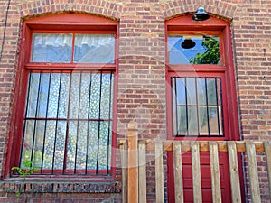 Old fashioned brick building with a barred window and door
