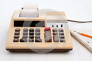 Old Fashioned Calculator on Desk with Paper