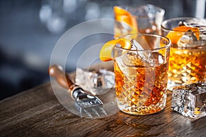 Old fashioned classic rum cocktail on ice with orange zest garnish