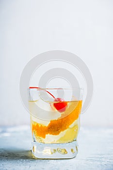 Old fashioned cocktail with cherry