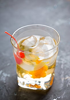 Old fashioned cocktail with cherry