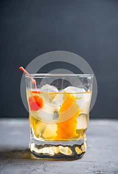 Old fashioned cocktail with cherry