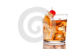 Old fashioned cocktail with orange and cherry isolated