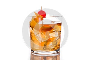 Old fashioned cocktail with orange and cherry isolated on white background.