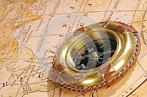 Old-fashioned compass on an old map