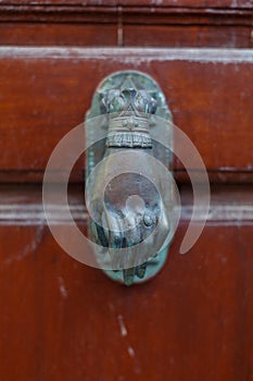 Old fashioned door knocker on the brown wooden door, Hydra Island, Greece