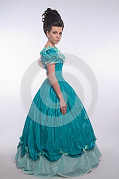 Old fashioned girl in cyan dress