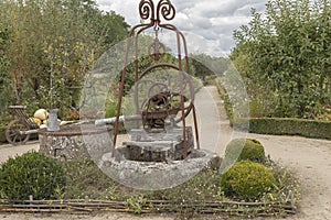 Old fashioned hand water pump in a vegetable garden