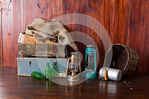 Old-fashioned kerosene lantern lamps with oil lamps in an antique warehouse warehouse with vintage wooden drawers.